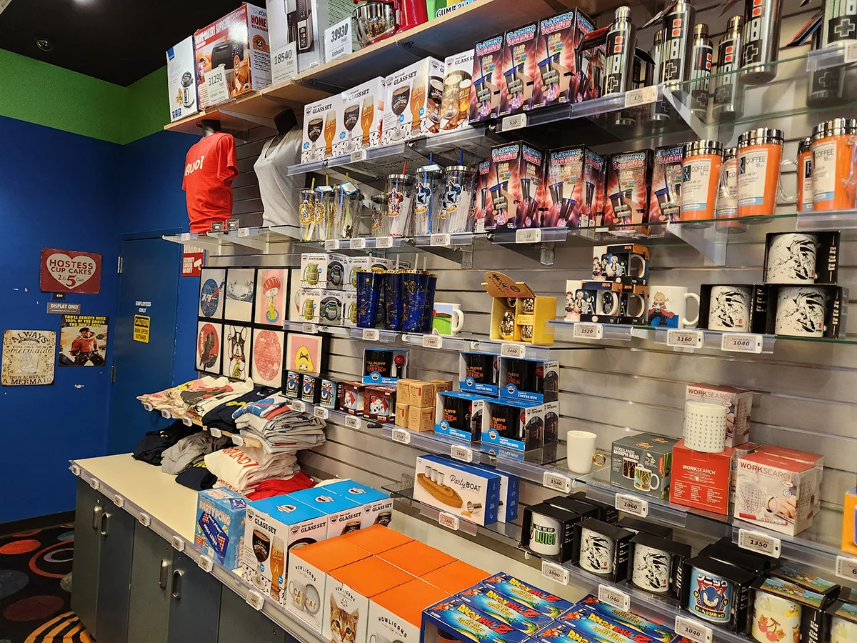 Retail store display with mugs, tumblers, and novelty gift items