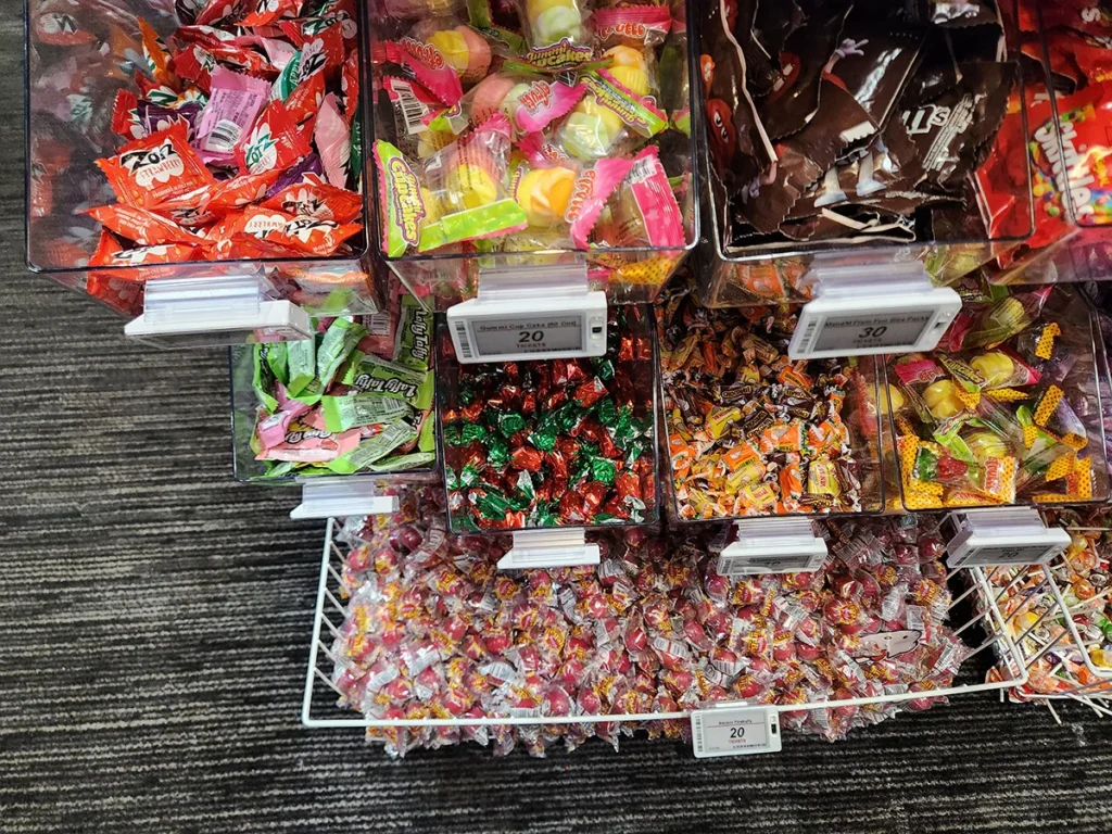 Retail candy display with electronic shelf labels showing real-time pricing