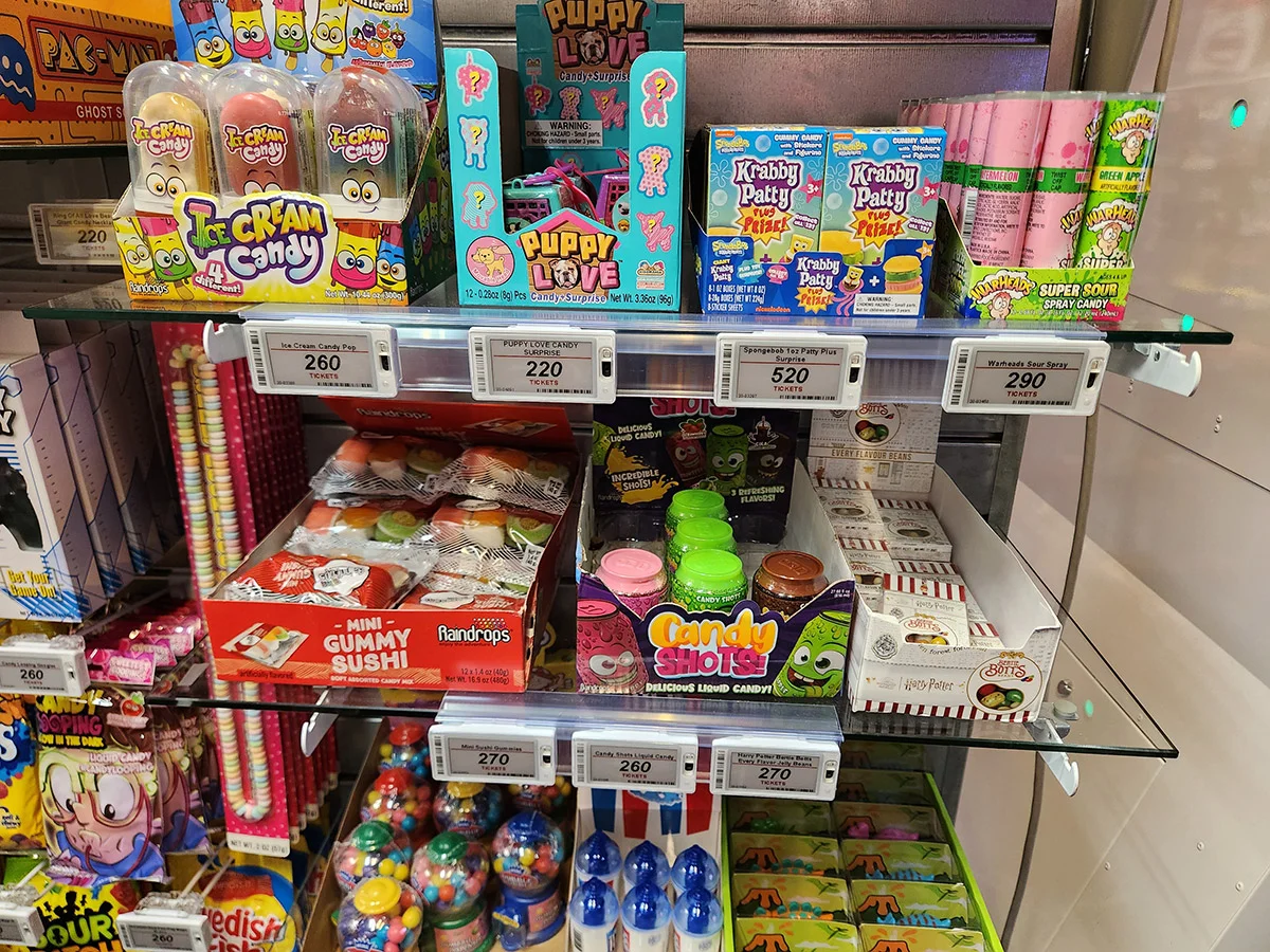 Retail candy shelf with assorted sweets, gummies, and novelty candy products