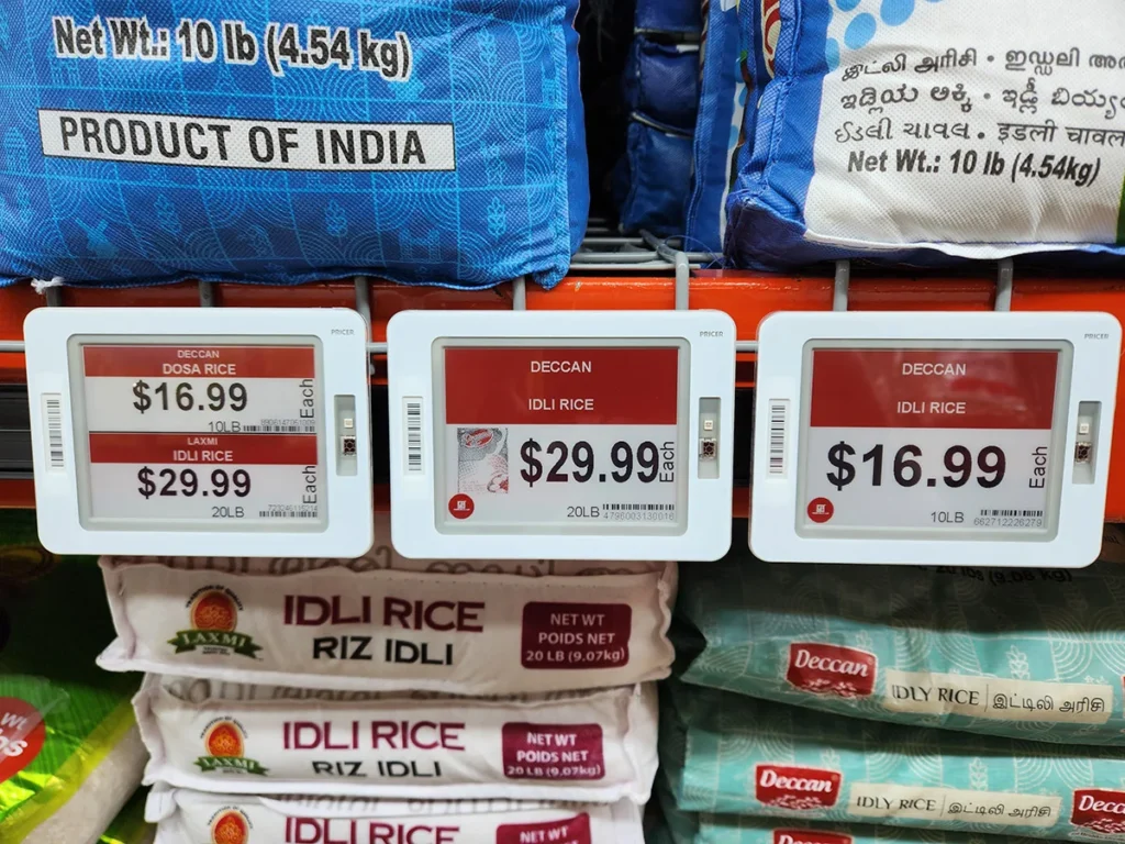 Grocery store display with idli rice and dosa rice bags and digital price tags
